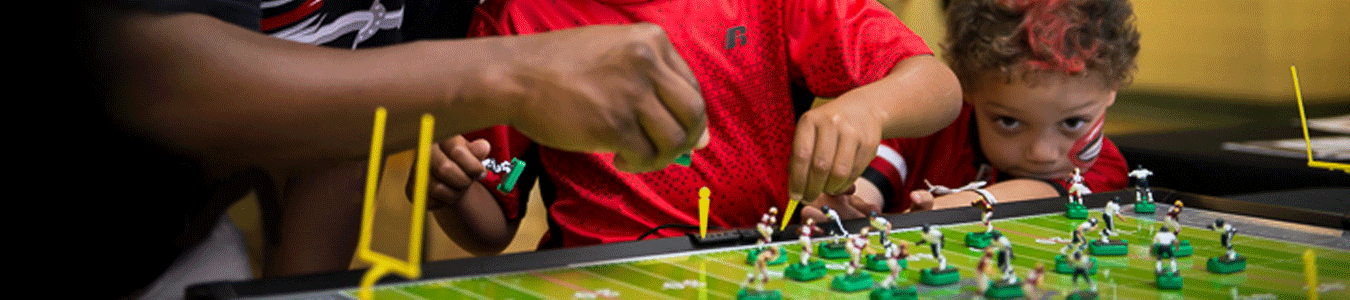 Family playing Electric Football on Tudor Games board